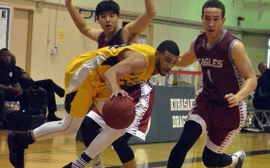 Kadena's Justin Wilson nearly loses his purchase as American School of Bangkok's Wei Huang and Jalen Lomax give chase during Wednesday's semifinal in the Far East Boys Division I Basketball Tournament. The Panthers downed the Eagles 57-50.