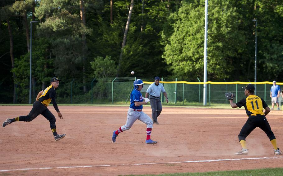 Ramstein's Josh Harris is caught between Vicenza's Joshua Thaniel, right, and John Nelson during the DODEA-Europe baseball tournament in Kaiserslautern, Germany, on Thursday, May 25, 2017. Harris was tagged out at third.
