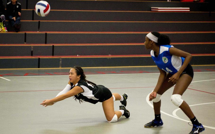 Ramstein's Cristeana Reyes, left, dives for the ball as Aviano's De'Jah Tripp watches in Kaiserslautern, Germany, on Saturday, Nov. 12, 2016, during the DODEA-Europe volleyball All Star match.