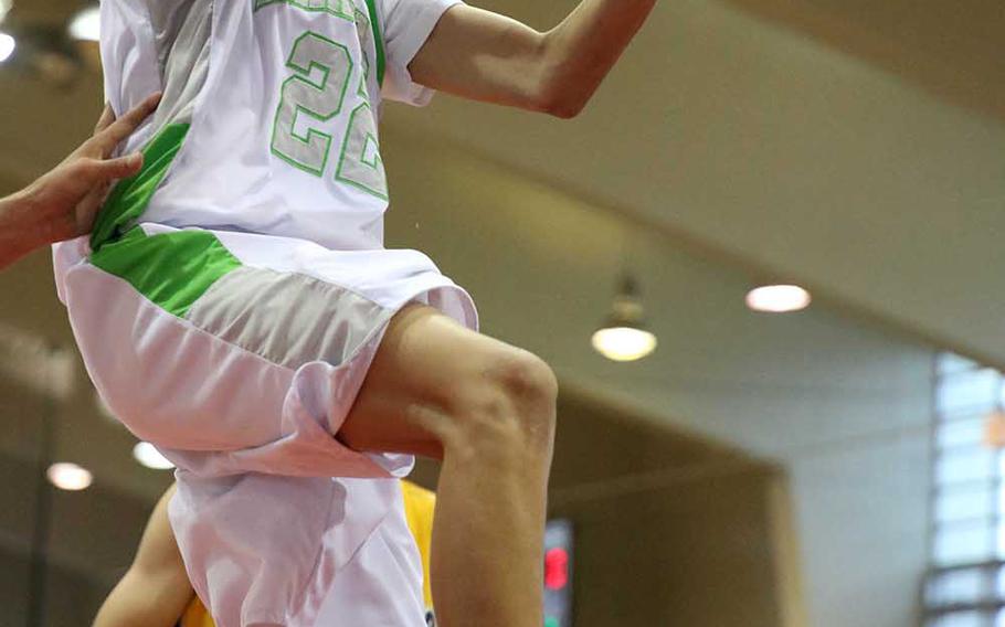 Kubasaki's Elonzo Higginson III puts up a shot past the Kitanakagusuku defense during Sunday's championship game in the 11th Okinawa-American Friendship Basketball Tournament. The Dragons lost to the Fighting Lions 63-50. Higginson leads the Dragons into the 12th edition of the Friendship Tournament this weekend at the same Foster Field House.