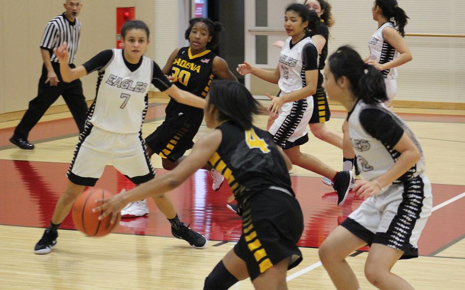 Kadena's Rhamsey Wyche drives up court toward American School of Bangkok's hanique Lucas (7) and Wyche's teammate Atirria Simms (30) during Tuesday's final in the Far East Girls Division I Basketball Tournament. The Eagles repeated their title of a year ago, beating the Panthers 44-35.