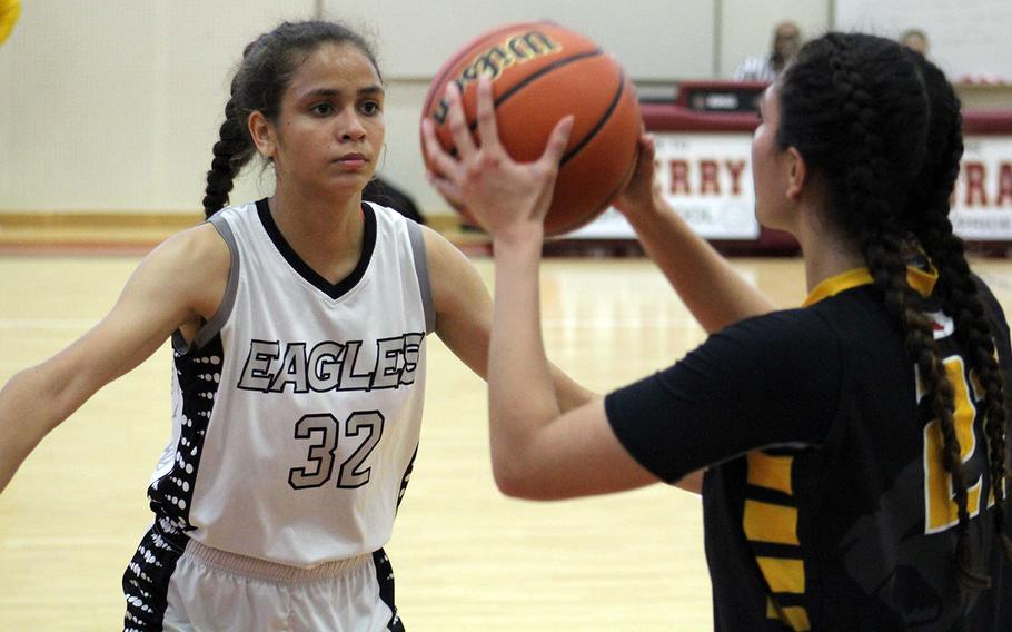 Kadena's Isabel Tayag squares up with the ball against American School of Bangkok's Keisharna Lucas during Tuesday's final in the Far East Girls Division I Basketball Tournament. The Eagles repeated their title of a year ago, beating the Panthers 44-35.
