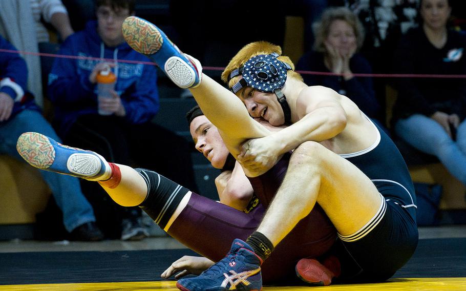 Munich's Blaise Ronnau, right, tries to turn Vilseck's Matthew Johnston during the DODEA-Europe wrestling championships in Wiesbaden, Germany, on Saturday, Feb. 17, 2018. Ronnau won the 160-pound final match against Johnston 8-7. 