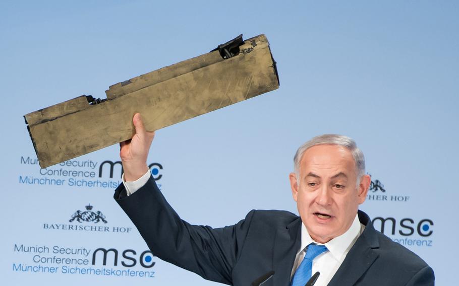 Israeli Prime Minister Benjamin Netanyahu displays a piece of what he said was an Iranian drone that Israel shot down during a speech Sunday, Feb. 18, 2018, at the Munich Security Conference.
