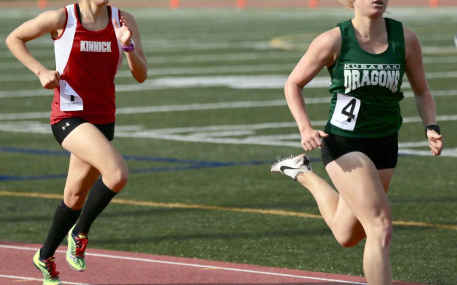 Kubasaki's Elizabeth Joy leads Nile C. Kinnick's Taryn Cates-Beier, the reigning Far East cross country champion, toward the finish of Monday's 1,600 final in the Far East track and field meet. Joy edged Cates-Beier 5:21.66 to 5:22.68.