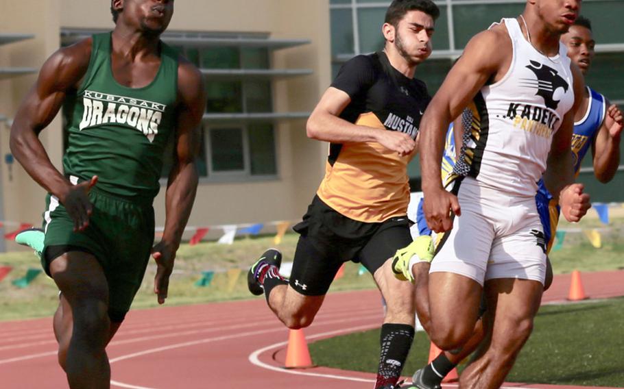 Kadena's Eric McCarter and Kubasaki's Vincent Hill lead the pack around the far turn in Monday's boys 200 preliminary run in the Far East track and field meet. McCarter won in 22.19 seconds.
