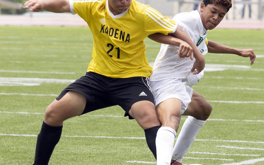 Kadena's Sam Martineau ties up Kubasaki's Ryo Elliot during Wednesday's final in the Far East Division I boys soccer tournament. The Dragons pulled away in the second half for a 4-0 win. Elliiott was named the tournament's MVP.
