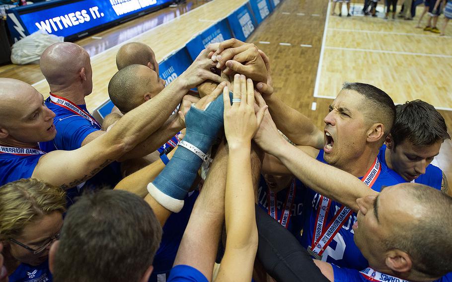 Team Air Force huddles together to show each support after winning the silver medal in the sitting volleyball finals at the DoD Warrior Games, June 8, 2018, at the U.S. Air Force Academy in Colorado Springs, Colorado. 