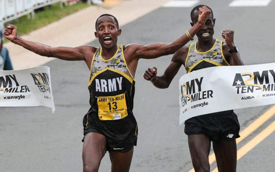 Spc. Frankline Tonui crosses the finish line ahead of Army Sgt. Evans Kirwa, taking first place at the 2018 Army Ten-Miler held in Washington, D.C., on Sunday, Oct. 7, 2018.