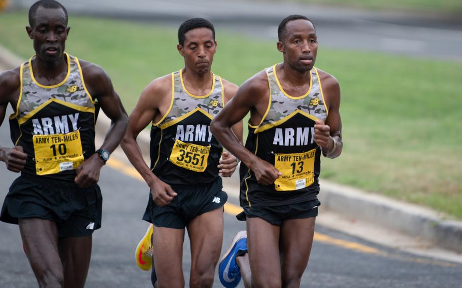Evans Kirwa, far left, Girma Mecheso, center, and Frankline Tonui (who placed second, third and first respectively) shortly before the Mile 4 marker during the Army Ten-Miler. 
