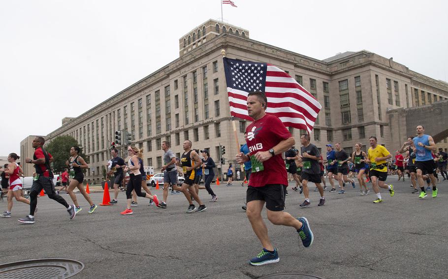 Runners pass the Department of Agriculture headquarters in Washington, D.C. during the Army Ten-Miler, Oct. 7, 2018.