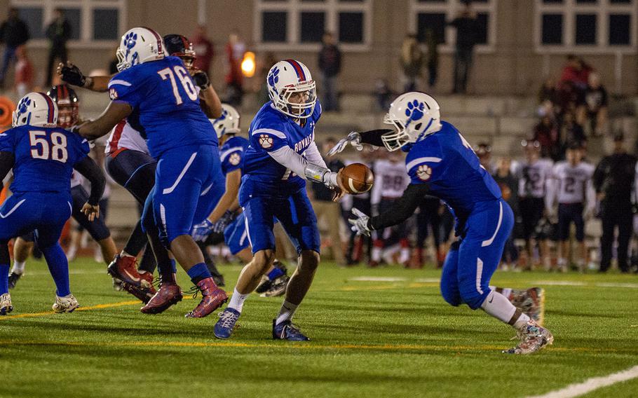 Jakob Steinbeck hand the ball off to Dominque Arizpe during the DODEA-Europe Division I football championship game between the Ramstein Royals and the Lakenheath Lancers, Saturday, Nov. 3, 2018. 
