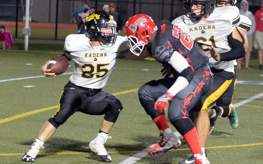 Kadena quarterback Wyatt Knopp tries to run around Kinnick defender Marcus Marion.