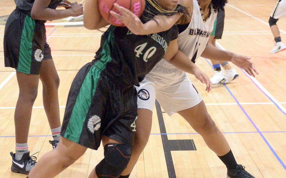 Humphreys' Alex Easterling reaches in to knock the ball loose from Daegu point guard Bethani Newbold.