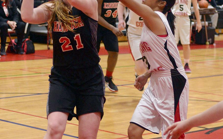 Nile C. Kinnick's Cassi Boyer shoots against Halle Santiago of E.J. King during Thursday's DODEA-Japan tournament girls playoff game. The Red Devils won 35-18.