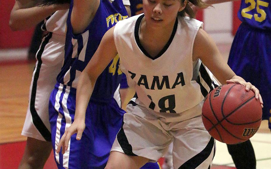Zama's Kirari Smith tries to work past Yokota defender Keiya Carlson during Friday's DODEA-Japan Tournament championship game. The Trojans won 35-16 to dethrone the four-time defending champion Panthers.