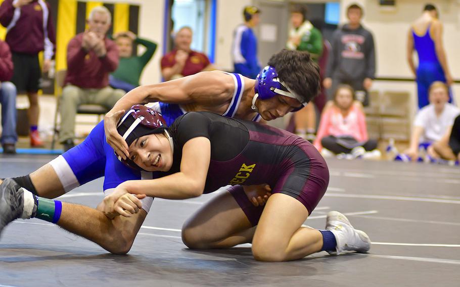 Vilseck's Jada Llamido attempts to take down Rota's Kaden Rodriguezl. Llamido won the 126-pound match and took first at the Southern wrestling sectional at Vicenza, Italy.
