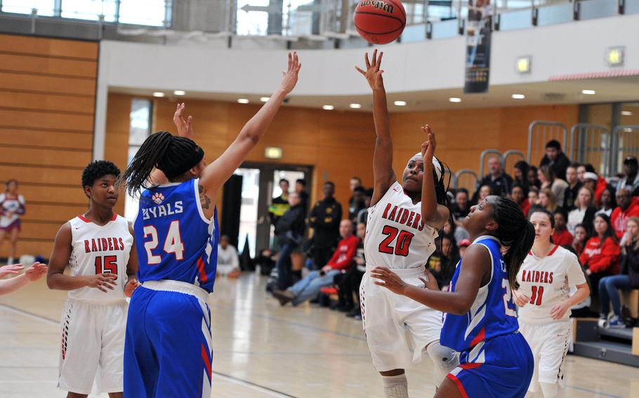 Kaiserslautern's Mikaila Bell shoots over Ramstein's Shemilia Johnson in a Division I game at the DODEA-Europe basketball championships in Wiesbaden, Germany. Ramstein won the game 33-24.





