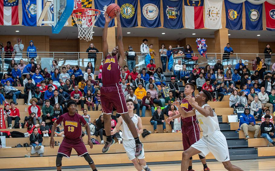 Baumholder's Lawrence Huxtable grabs a rebound during the Division III basketball championship game between Baumholder and Ansbach at Clay Kaserne Fitness Center, Germany, Saturday, Feb. 23, 2019. Baumholder won the game 70-65. 
