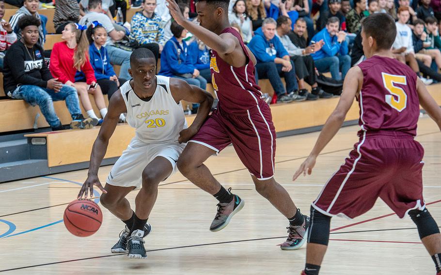 Ansbach's Kevin Kamara dribbles past a defender during the Division III basketball championship game between Baumholder and Ansbach at Clay Kaserne Fitness Center, Germany, Saturday, Feb. 23, 2019. Baumholder won the game 70-65. 