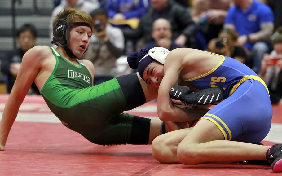 St. Mary's Jasjot Bedi laces up the legs of Kubasaki's Caleb Orr at 129 pounds.
