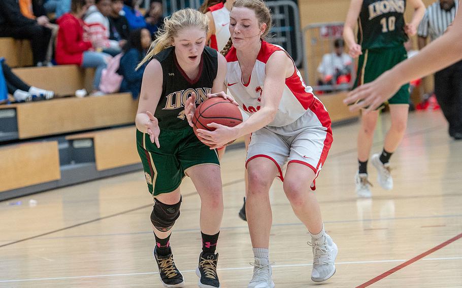 AFNORTH's Tori Morris and AOSR's Evan Park go for the ball during the Division II basketball championship game between AFNORTH and AOSR at Clay Kaserne Fitness Center, Germany, Saturday, Feb. 23, 2019. AOSR won the game 20-15. 