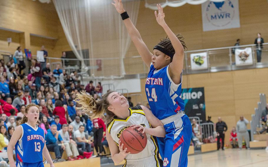 Shemilia Johnson goes up to block a shot from Stuttgart's Carly Sharp during the Division I basketball championship game between Ramstein and Stuttgart at Clay Kaserne Fitness Center, Germany, Saturday, Feb. 23, 2019. Stuttgart won the game 29-24. 