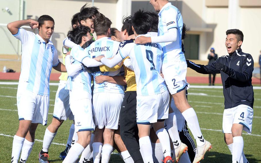 Chadwick International soccer players celebrate following their PK shootout win in Saturday's Perry Cup final over Kubasaki.