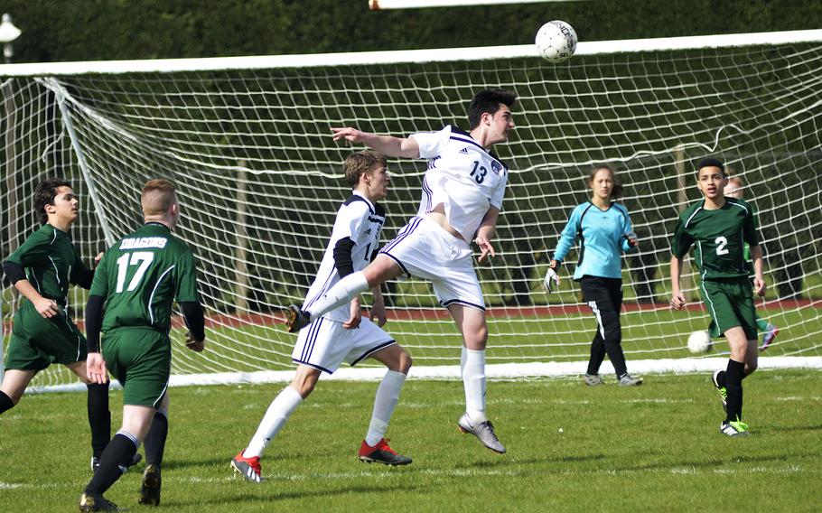 SHAPE soccer player Bathuan Usta heads the ball during a high school game against the Dragons at RAF Alconbury, England, Saturday, March 23, 2019. SHAPE won the game 7-0.