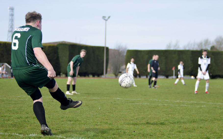 Alconbury senior Nick Brinegar boots the soccer ball during a high school game against SHAPE at RAF Alconbury, England, Saturday, March 23, 2019. SHAPE beat the Dragons by halftime with a 7-0 score.
