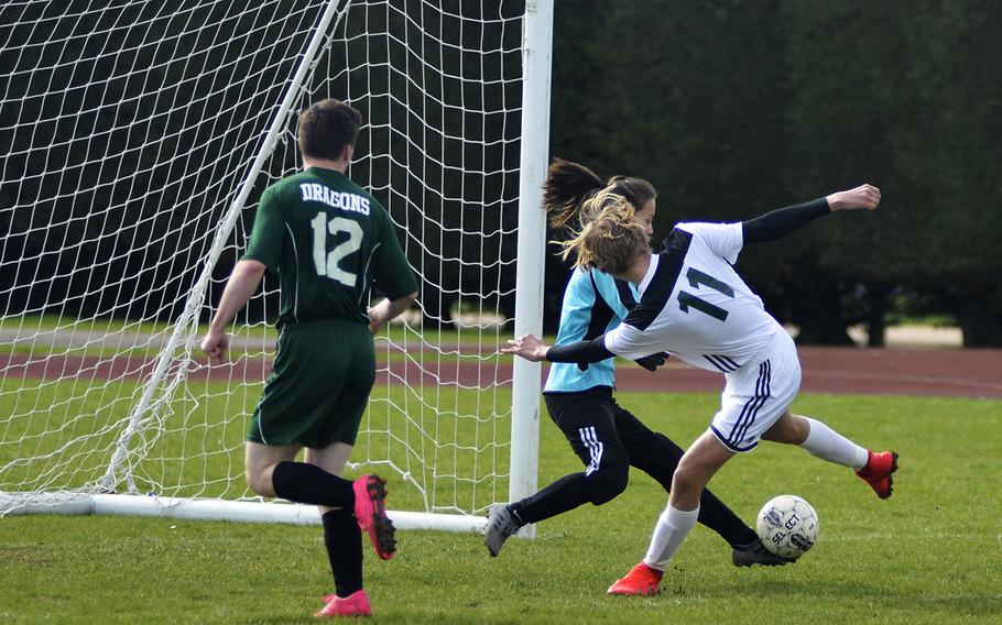 Alconbury's sophomore goal keeper Alyssa Beighle blocks a shot from SHAPE player Sverre Loso during a high school soccer game at RAF Alconbury, England, Saturday, March 23, 2019. Beighle had 14 saves and multiple grabs.

