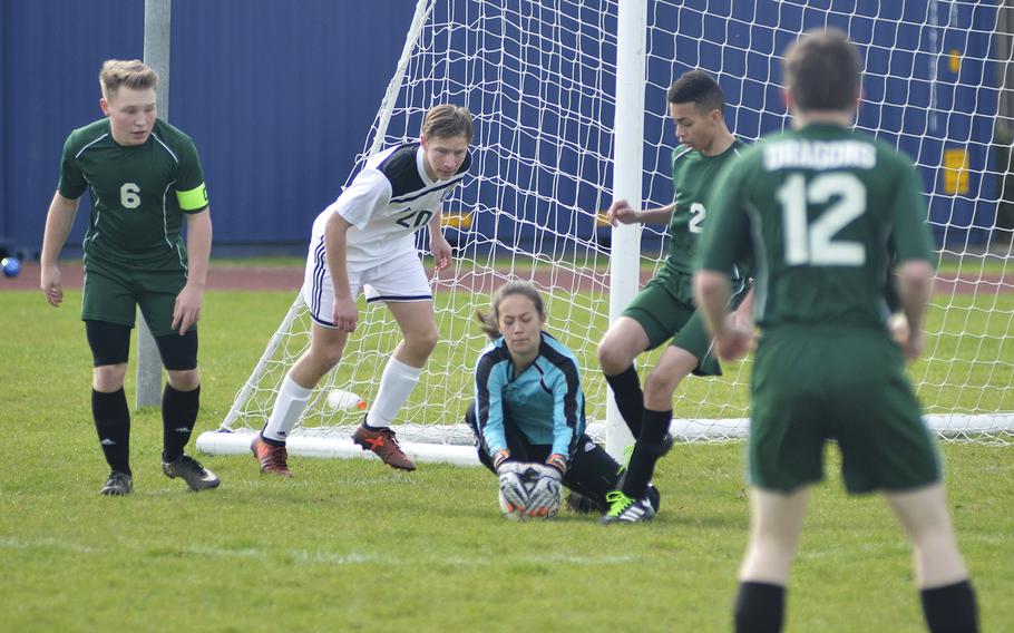 Alconbury's sophomore goalkeeper Alyssa Beighle secures the soccer ball during a high school game against SHAPE at RAF Alconbury, England, Saturday, March 23, 2019. Beighle had 14 saves and multiple grabs.