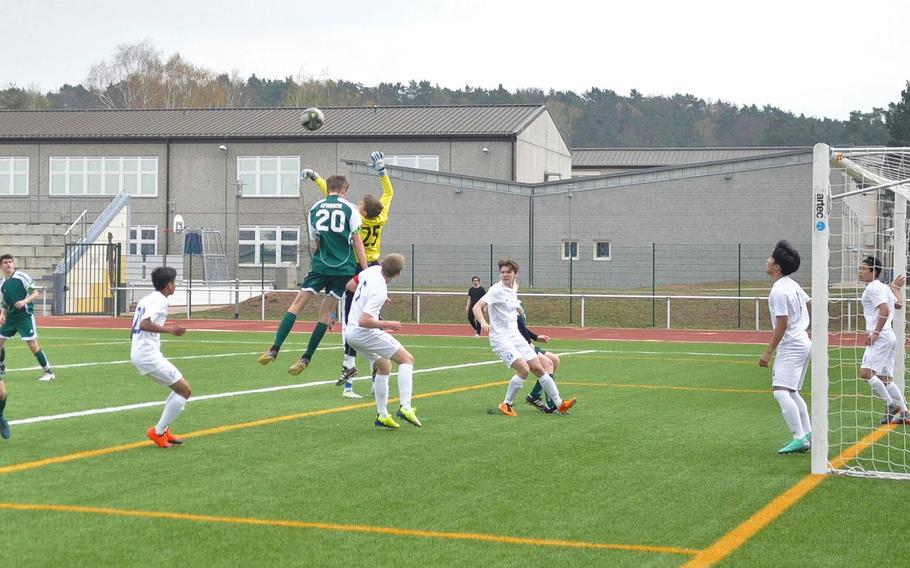 Black Forest Academy goalkeeper Jacob Kleager and AFNORTH opponent Lasse Bohlen vie for a ball Saturday, April 6, 2019, at Kaiserslautern High School. The Lions won the neutral-field matchup 3-1.