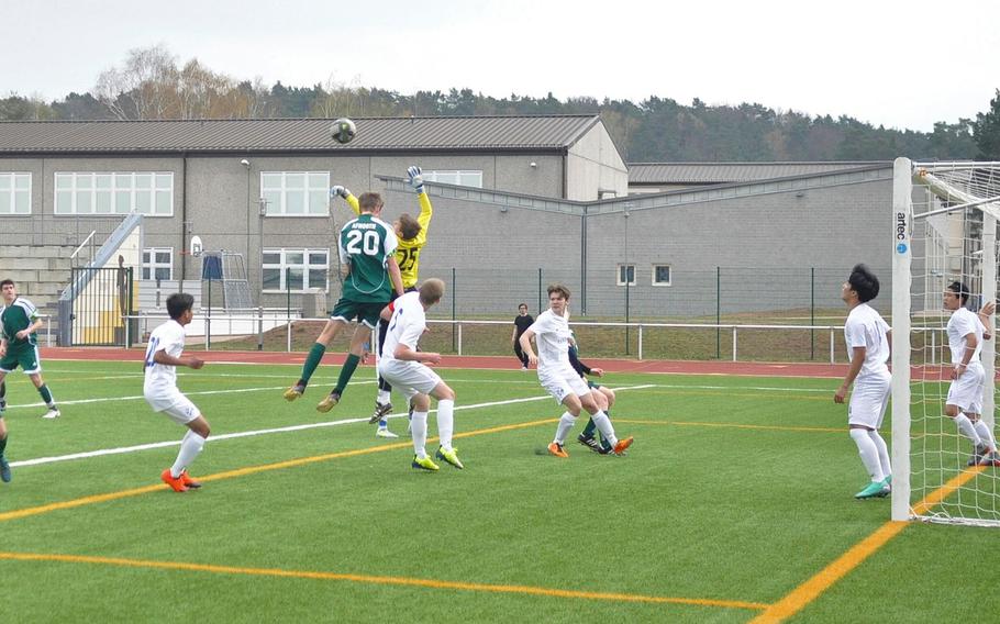 Black Forest Academy goalkeeper Jacob Kleager and AFNORTH opponent Lasse Bohlen vie for a ball Saturday, April 6, 2019, at Kaiserslautern High School. The Lions won the neutral-field matchup 3-1. 
