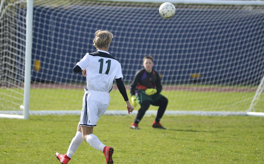 SHAPE's Sverre Loso shoots against Alconbury goal keeper Jack Hayosh during the opening minutes of a high school soccer game at RAF Alconbury, England, Saturday, March 23, 2019.