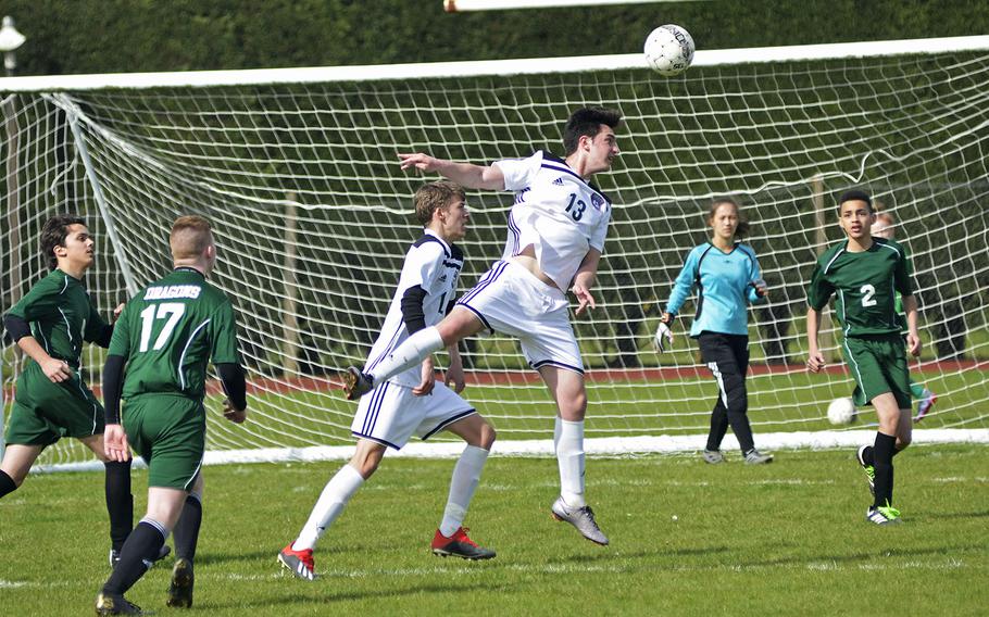 SHAPE soccer player Bathuan Usta gets a header during a high school game against the Dragons at RAF Alconbury, England, Saturday, March 23, 2019. SHAPE won the game 7-0.