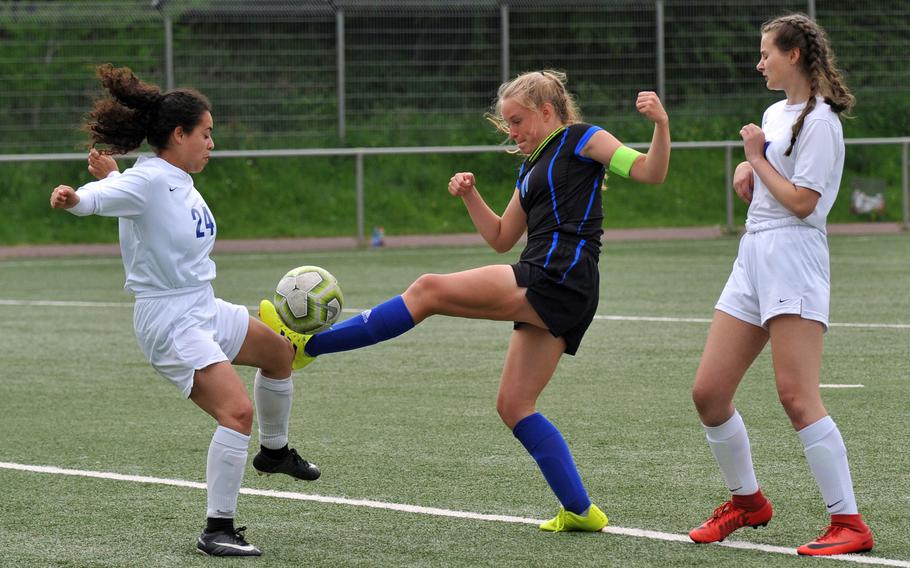 Brussels Sophia Beckley, left, blocks a shot attempt by Hohenfels' Lucy Wylie in a Division III game at the DODEA-Europe soccer finals in Landstuhl, Monday, May 20, 2019.
