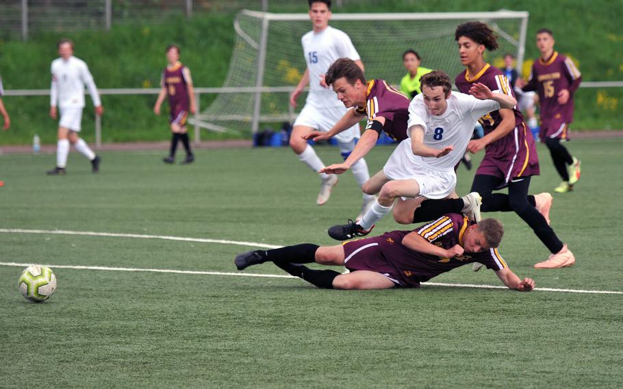 Brussels' Nathan Pierce gets upended by a trio of Baumholder players, from left, Hylan James, Noel King and Stephan Christmas, in a Division III game at the DODEA-Europe soccer finals in Landstuhl, Monday, May 20, 2019. Brussels won 3-1.










