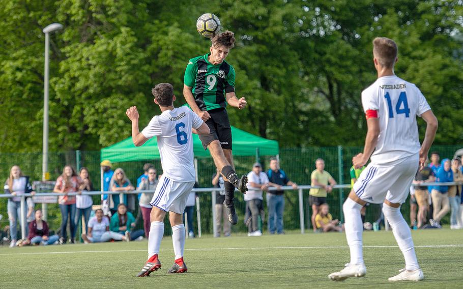 Naples' Christian Albright goes up for a header during a Division I semifinal game against Wiesbaden on the third day of the DODEA-Europe soccer championships, Wednesday, May 22, 2019.