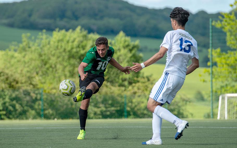 Naples' Nikolas Mihalik takes a shot on goal during a Division I semifinal game against Wiesbaden on the third day of the DODEA-Europe soccer championships, Wednesday, May 22, 2019.