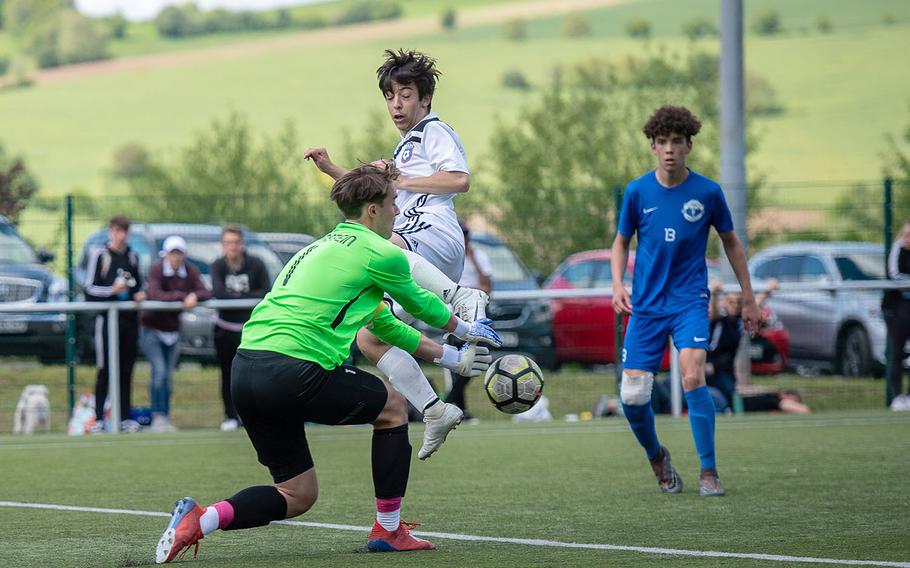 Ramstein's Garrett Erickson stop a shot from SHAPE's Joseph Kraemer during a Division I semifinal game on the third day of the DODEA-Europe soccer championships, Wednesday, May 22, 2019.
