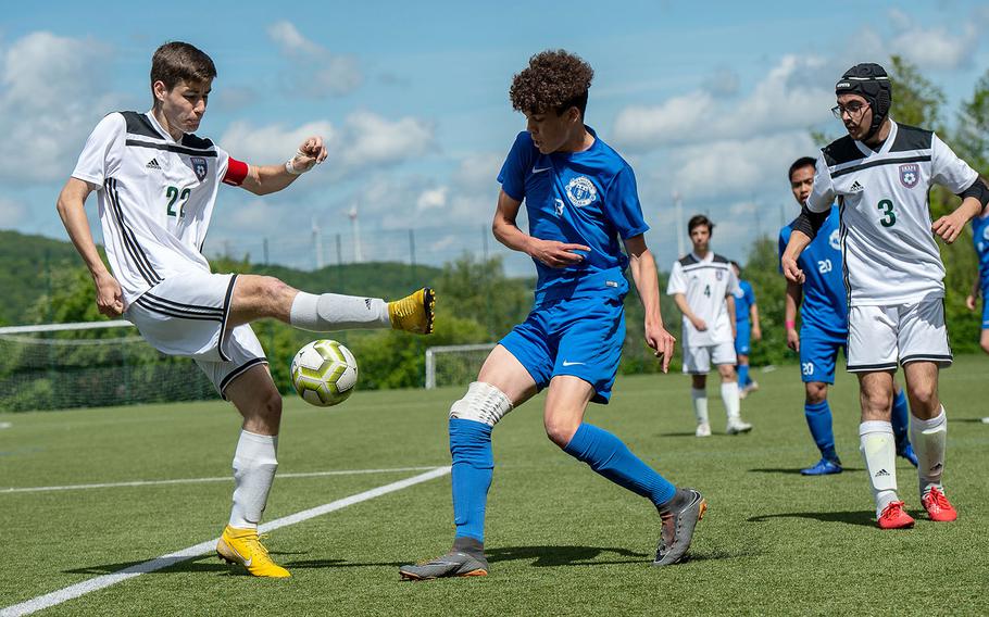Ramstein's Hunter Smith block a kick from SHAPE's Gonzalo Vijande during a Division I semifinal game on the third day of the DODEA-Europe soccer championships, Wednesday, May 22, 2019.