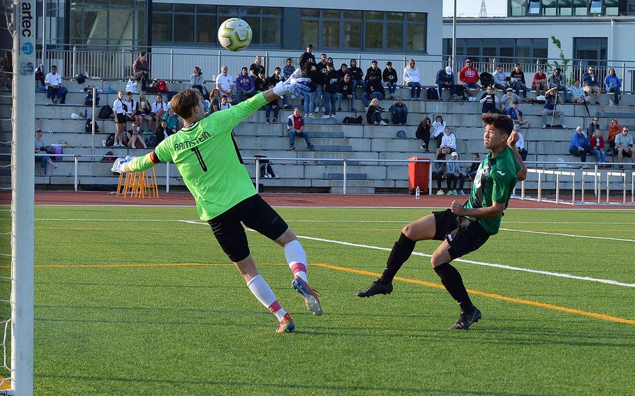 Naples' Chase Traylor watches his shot sail over Ramstein keeper Garrett Erickson for the game-winning goal in the boys Division I final at the DODEA-Europe championships in Kaiserslautern, Thursday May 23, 2019. 