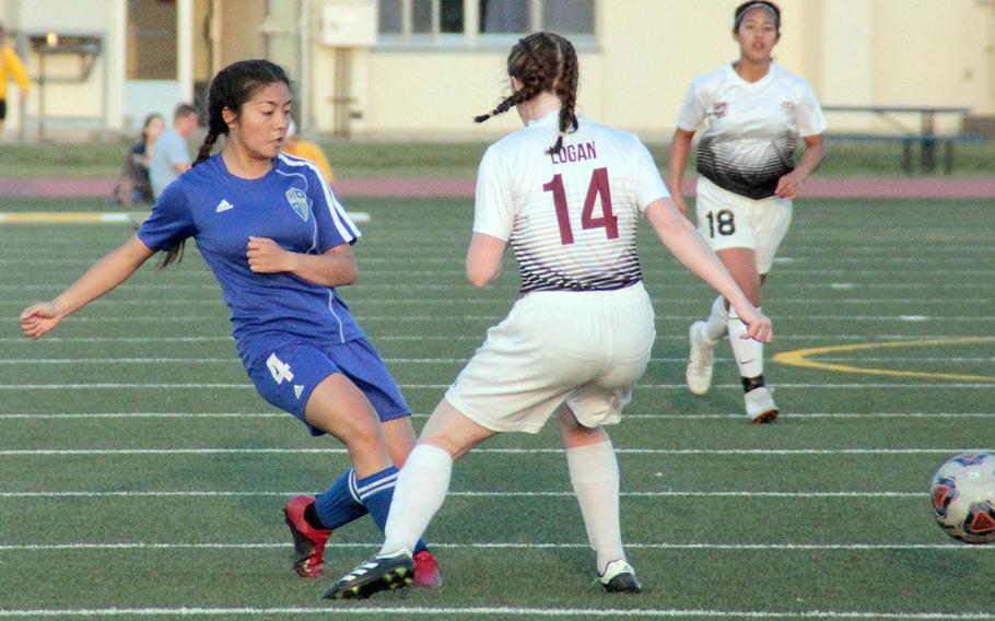 Yokota's Emma Oshiro boots the ball past Zama's Abigail Logan.