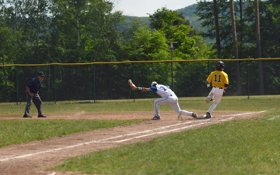 Stuttgart's Peter Buxkemper touches the base as Ramstein's Calvin Delp squeezes the ball in a close play at first in the championship game of the DODEA-Europe Division I championship game on Saturday, May 25, 2019.