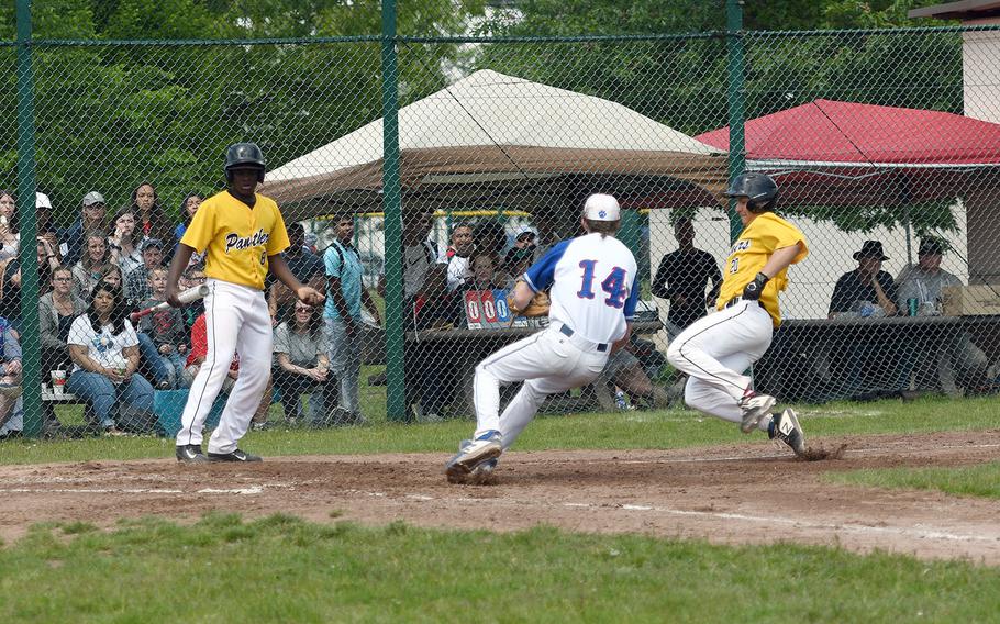 Stuttgart's Wesley Coglianese heads for home, while Ramstein's Tieran Shoffner blocks the way in the Royals' 5-4 victory in the championship game of the DODEA-Europe Divsion I championship on Saturday, May 25, 2019.