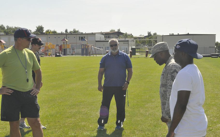 Head coach Mike Laue, center, talks with the Spangdahlem Sentinels football coaching staff Thursday, Aug. 22, 2019, at Spangdahlem Air Base. Laue, one of DODEA-Europe's most accomplished coaches, returns to the sideline this fall after a one year hiatus. 
