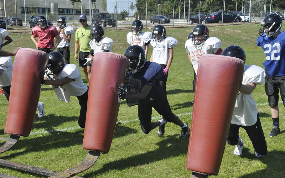 Spangdahlem Sentinels football players attack a tackling dummy in a preseason practice Thursday, Aug. 22, 2019 at Spangdahlem Air Base. The Sentinels are transitioning from 11-man to six-man football this fall, emphasizing the importance of open-field tackling. 
