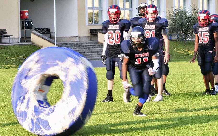 Aviano Saints football players perform tackling drills as part of a training session in preparation for their opening game of the 2019-20 school year.