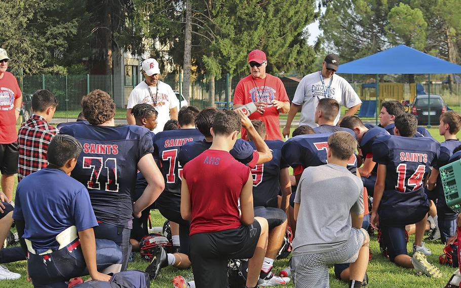 Aviano Saints football team head coach Rick Dahlstrom talks to his team following a training session in preparation for their opening game of the 2019-20 school year.